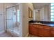 Granite counter tops accent this bathroom with a glass shower and ample vanity storage at 7969 Bermuda Dunes Ave, Las Vegas, NV 89113