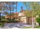 Inviting two-story home with a two-car garage, mature trees, and well-manicured landscaping at 7969 Bermuda Dunes Ave, Las Vegas, NV 89113