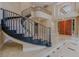 Grand entryway with marble floors, curved staircase, and custom lighting at 7969 Bermuda Dunes Ave, Las Vegas, NV 89113