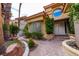 Stunning front entrance showcasing a unique, welcoming doorway with lush, mature landscaping at 7969 Bermuda Dunes Ave, Las Vegas, NV 89113