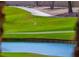 A picturesque golf course view includes a water feature, manicured green, and white flag in the distance at 7969 Bermuda Dunes Ave, Las Vegas, NV 89113