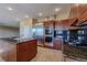 Modern kitchen with stainless steel appliances, island, and granite countertops at 7969 Bermuda Dunes Ave, Las Vegas, NV 89113