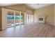Large living room features white floors, high ceilings, a fireplace, and access to a patio at 7969 Bermuda Dunes Ave, Las Vegas, NV 89113