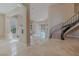 Spacious living room featuring a staircase, tile floors, and light-filled windows at 7969 Bermuda Dunes Ave, Las Vegas, NV 89113