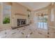 Spacious living area with tiled floors, fireplace, chandelier, and great views at 7969 Bermuda Dunes Ave, Las Vegas, NV 89113
