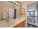 Bathroom with dual sinks, decorative mirror, and staircase view at 8039 Baldy Mountain Ave, Las Vegas, NV 89131