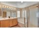 Bathroom featuring double sinks, tub, and glass shower at 8039 Baldy Mountain Ave, Las Vegas, NV 89131
