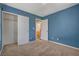 Blue bedroom with closet and doorway to ensuite bath at 8039 Baldy Mountain Ave, Las Vegas, NV 89131