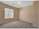 Neutral carpeted bedroom with a large window, offering ample natural light at 8039 Baldy Mountain Ave, Las Vegas, NV 89131