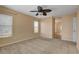 Bedroom with carpet flooring, ceiling fan, and view to bathroom at 8039 Baldy Mountain Ave, Las Vegas, NV 89131