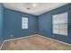 Carpeted blue bedroom with windows, offering ample sunlight and neutral trim at 8039 Baldy Mountain Ave, Las Vegas, NV 89131