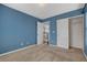 Blue bedroom with carpet, closet and doorway to hallway, and neutral trim at 8039 Baldy Mountain Ave, Las Vegas, NV 89131