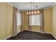A dining room showcases a modern light fixture and gray curtains that complement the yellow walls at 8039 Baldy Mountain Ave, Las Vegas, NV 89131