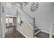 Inviting foyer featuring a staircase, hardwood floors, neutral walls, and elegant decor elements at 8039 Baldy Mountain Ave, Las Vegas, NV 89131