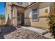 View of the front door and entrance featuring desert landscaping and neutral-colored exterior walls at 8039 Baldy Mountain Ave, Las Vegas, NV 89131