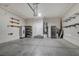 Spacious garage with overhead door, built in shelving, storage and access door to the home's interior at 8039 Baldy Mountain Ave, Las Vegas, NV 89131
