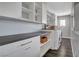 Laundry room with white cabinets, dark countertops, and stainless appliances at 8039 Baldy Mountain Ave, Las Vegas, NV 89131