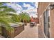 Private backyard featuring patio, outdoor dining area, hot tub, and lush landscaping at 8222 Sorrel St, Las Vegas, NV 89139