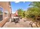 Cozy backyard with dining set, fire pit, lush landscaping, and sunny skies at 8222 Sorrel St, Las Vegas, NV 89139