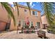 Backyard featuring outdoor dining, privacy fence, and tropical landscaping at 8222 Sorrel St, Las Vegas, NV 89139