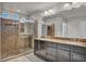 Bathroom featuring double sinks, granite counters, and a modern glass-enclosed shower at 8222 Sorrel St, Las Vegas, NV 89139