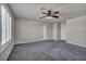 Comfortable bedroom with gray carpet, ceiling fan, and shutters on the windows at 8222 Sorrel St, Las Vegas, NV 89139