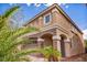 Charming stucco home featuring stone accents, a covered entryway, and lush landscaping at 8222 Sorrel St, Las Vegas, NV 89139
