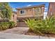 Home with manicured landscaping, paver driveway, and two-car garage at 8222 Sorrel St, Las Vegas, NV 89139