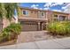 Charming two-story home with stucco siding, arched stone accents, and a paved driveway at 8222 Sorrel St, Las Vegas, NV 89139