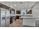 Well-equipped kitchen with stainless steel appliances and a center island with marble accents at 8222 Sorrel St, Las Vegas, NV 89139