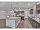 Modern kitchen with stainless steel appliances, granite counters and island, and hardwood flooring at 8222 Sorrel St, Las Vegas, NV 89139