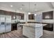 Modern kitchen featuring stainless steel appliances, granite countertops, and a stylish center island at 8222 Sorrel St, Las Vegas, NV 89139
