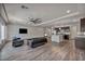 Spacious living room with modern finishes, sleek furniture, and an open floor plan to the kitchen at 8222 Sorrel St, Las Vegas, NV 89139
