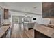 Bright living room offering an open layout with kitchen access, modern finishes, and wood laminate flooring at 8222 Sorrel St, Las Vegas, NV 89139