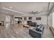 Expansive living area featuring wood-style flooring, modern sofas, and an integrated kitchen at 8222 Sorrel St, Las Vegas, NV 89139