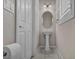 Neat powder room featuring pedestal sink, tiled floors, and plantation shutters at 8222 Sorrel St, Las Vegas, NV 89139