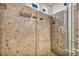 Modern walk-in shower with marble tile and built-in storage shelves at 8222 Sorrel St, Las Vegas, NV 89139