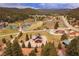 An aerial shot showcasing a serene mountain community with lush green trees and a flowing river at 855 E Ponderosa Rd, Mammoth Creek, UT 84735