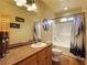 Well-lit bathroom with wood cabinets, a large mirror, and a shower-tub combination at 855 E Ponderosa Rd, Mammoth Creek, UT 84735