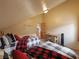 Cozy bedroom featuring two beds with plaid bedding, wood decor, and natural light at 855 E Ponderosa Rd, Mammoth Creek, UT 84735