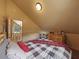 Bedroom features a wooden bed frame, wood dresser, and a view of the upstairs living room at 855 E Ponderosa Rd, Mammoth Creek, UT 84735