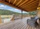 Inviting wooden deck with comfortable seating and views of the surrounding forest at 855 E Ponderosa Rd, Mammoth Creek, UT 84735