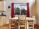 Dining room featuring rustic wood table and red accents with beautiful views of the surrounding woods at 855 E Ponderosa Rd, Mammoth Creek, UT 84735