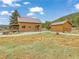 Log home with detached garage on a spacious grassy lot and metal roof at 855 E Ponderosa Rd, Mammoth Creek, UT 84735