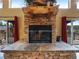 Elegant stone fireplace with a wooden mantel and views of the outdoor deck at 855 E Ponderosa Rd, Mammoth Creek, UT 84735