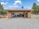 A log-style one-car garage featuring an open door and abundant storage space at 855 E Ponderosa Rd, Mammoth Creek, UT 84735