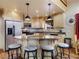 Well-lit kitchen with modern appliances, wooden cabinets, and a breakfast bar at 855 E Ponderosa Rd, Mammoth Creek, UT 84735