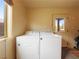 Bright laundry area featuring white appliances with a view outside at 855 E Ponderosa Rd, Mammoth Creek, UT 84735