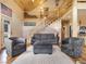 Bright living room featuring a wooden staircase and comfortable seating at 855 E Ponderosa Rd, Mammoth Creek, UT 84735