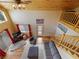 Living room with hardwood floors, high ceilings, staircase, and large window at 855 E Ponderosa Rd, Mammoth Creek, UT 84735